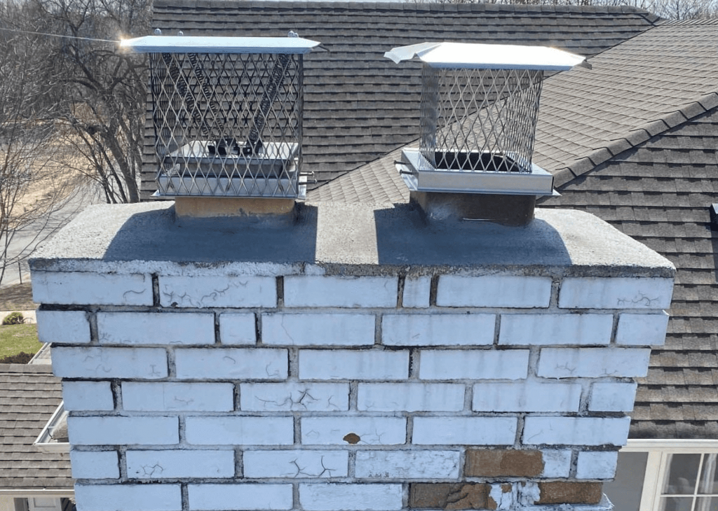 Cracked and spalling chimney masonry before repair
