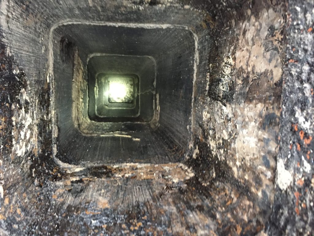 Dirty chimney flue interior before cleaning