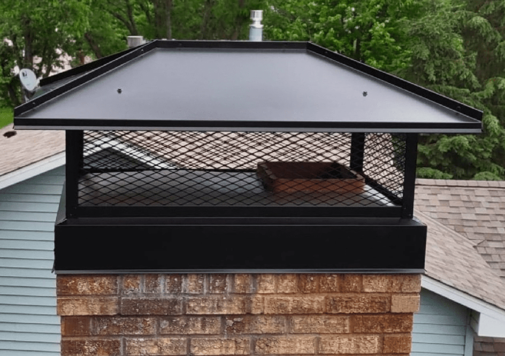 New custom black chimney cap installed after crown repair