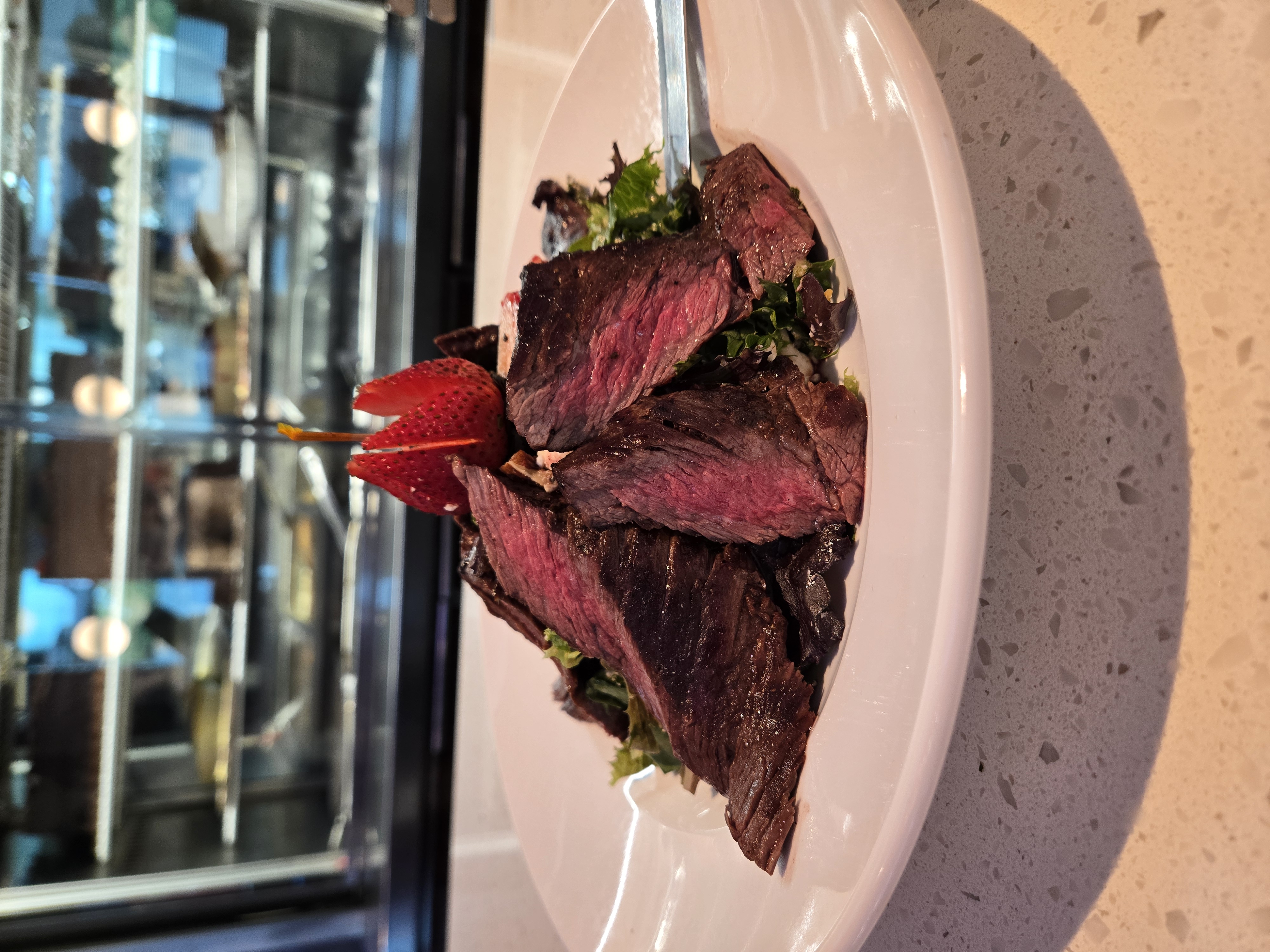Steak salad with mixed greens and strawberry