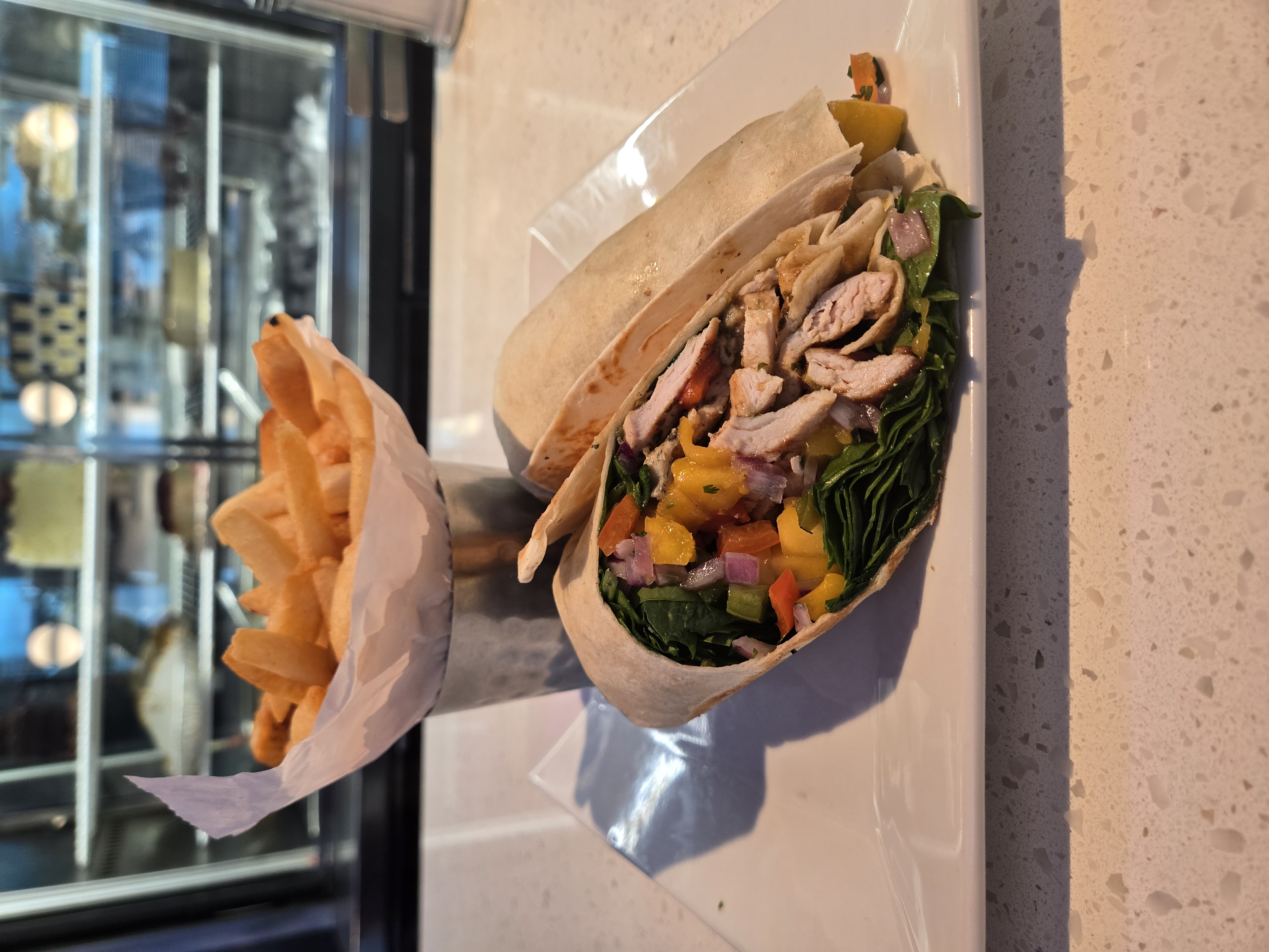 Chicken wrap with peppers and french fries