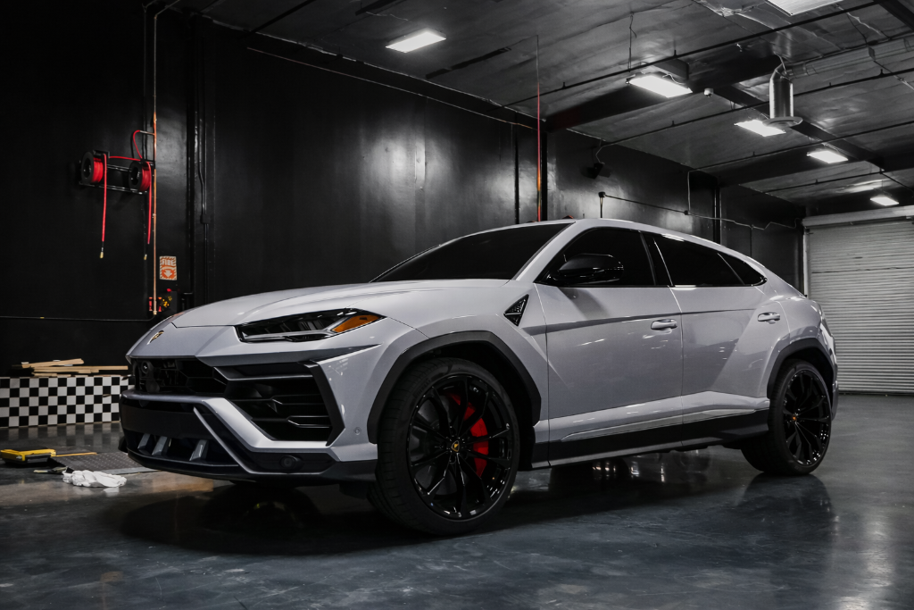 Silver Lamborghini Urus in tint shop garage Freehold NJ