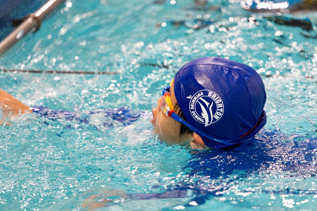 Child swimming in Brighton cap