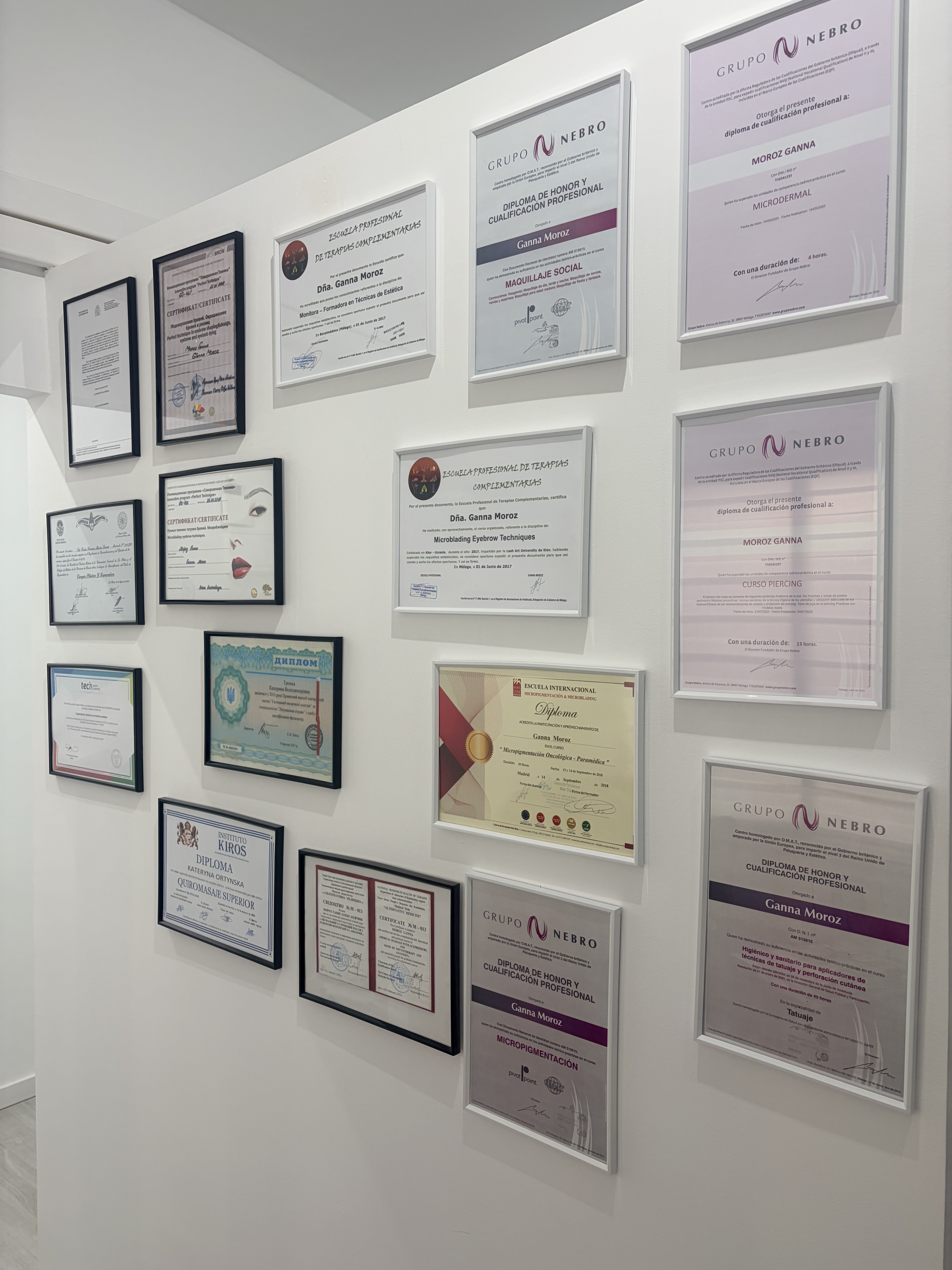 Pared de certificaciones y diplomas de medicina estética Clínica ISIS Benalmádena