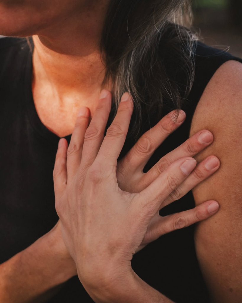 A hand resting gently on a shoulder