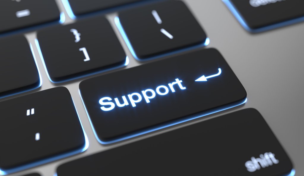 Close-up of a glowing Support key on a black keyboard