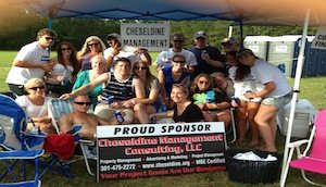 Cheseldine Management team under a sponsor tent at a local outdoor event