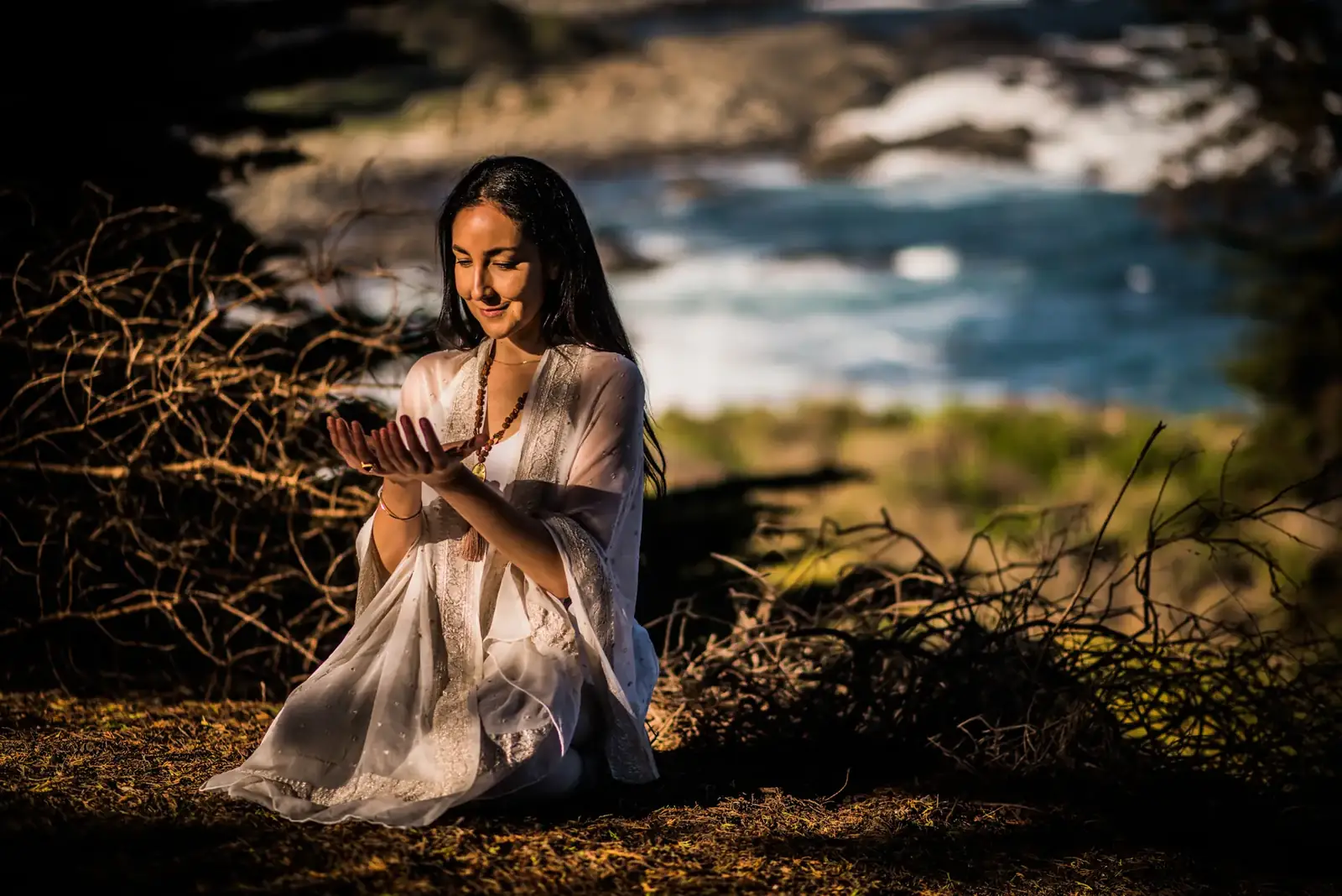 Camila Healing en meditación frente al mar