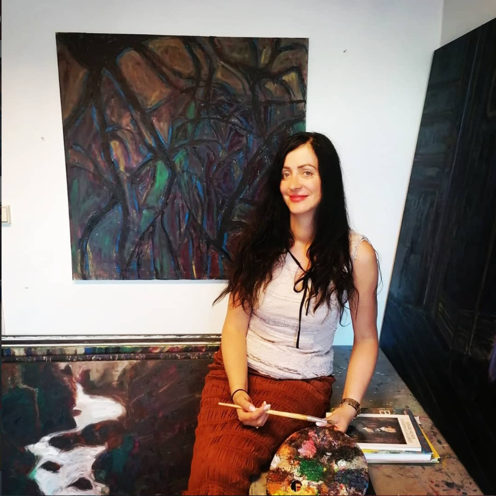 Artist hands working on a textured painting