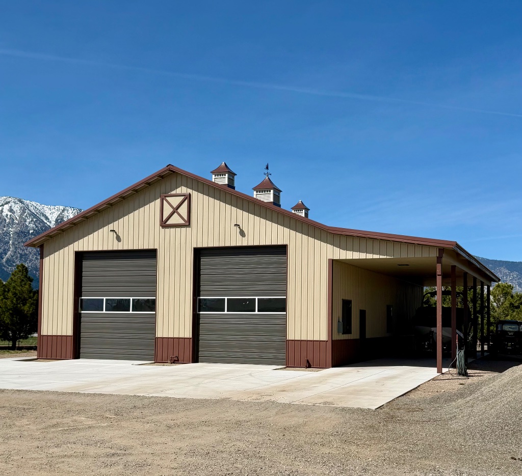 Custom horse barn with cupolas and covered entry in Minden Nevada by Hoyle Construction
