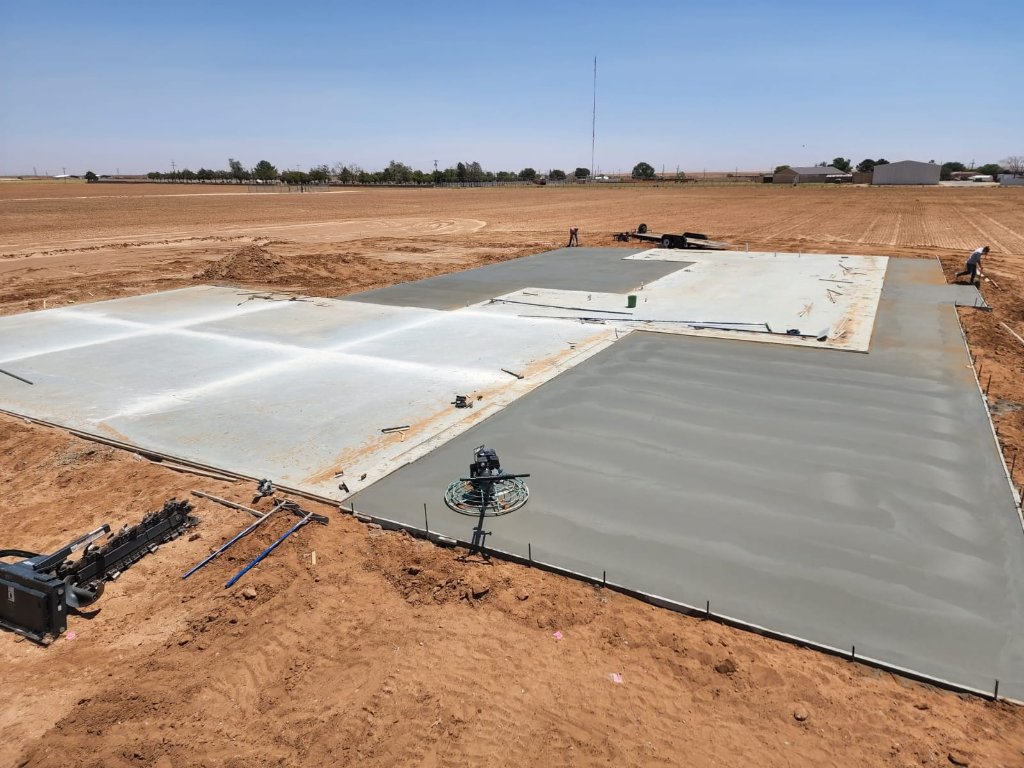 Freshly finished concrete patio slab with power trowel on a rural job site