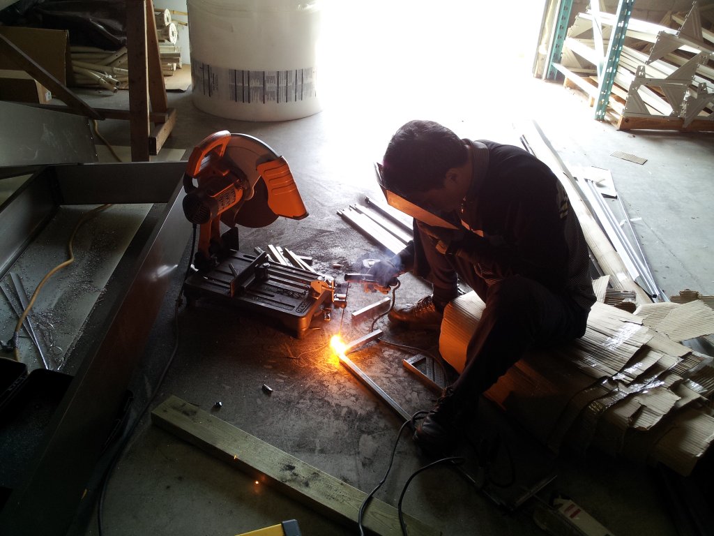 Craftsman cutting metal in the workshop