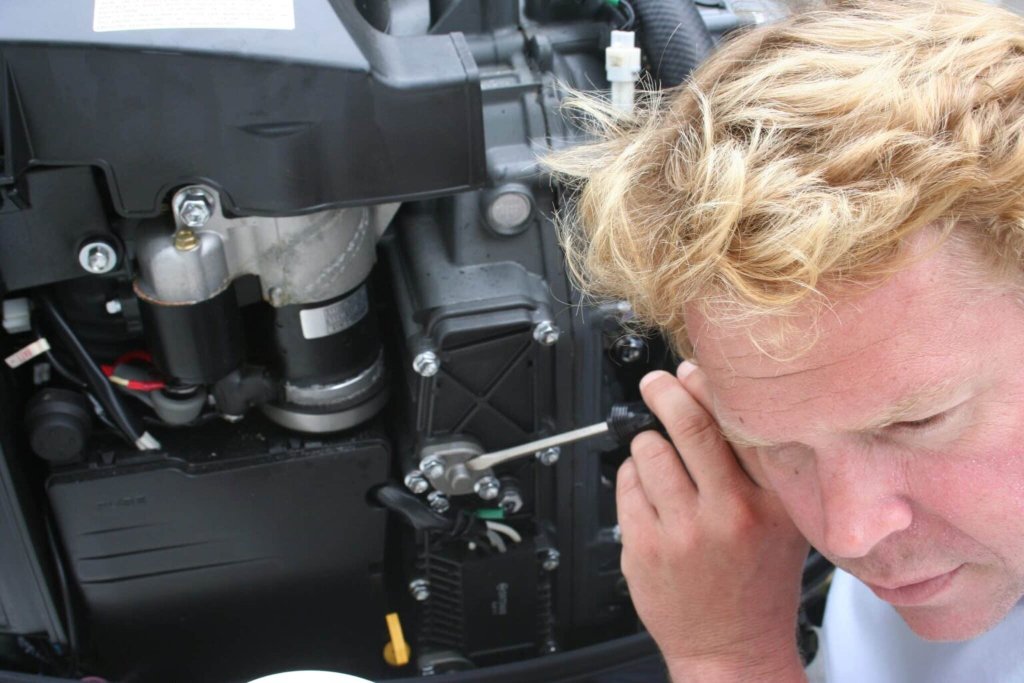 Machine health checks - mechanic listening to engine