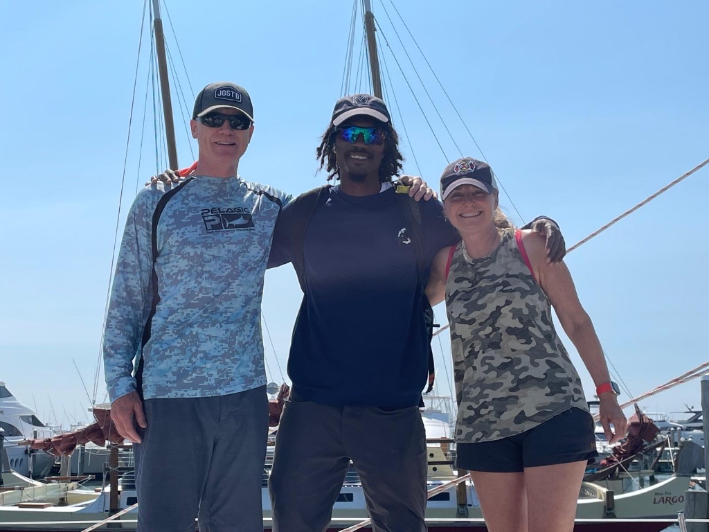 Deshawn with satisfied clients at marina — professional boat detailing St. Thomas USVI