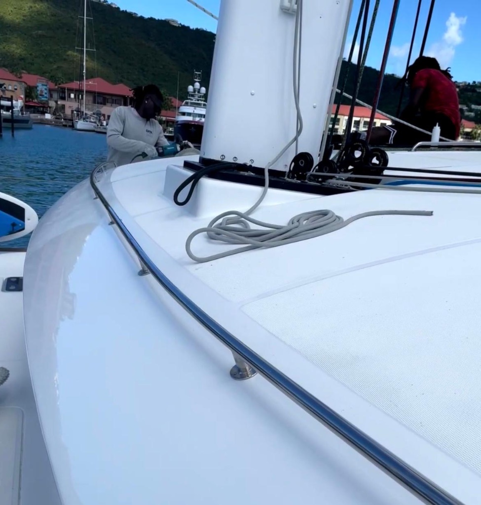 Crew polishing catamaran bow at Crown Bay Marina — Scrubbies Boat Wash 340 St. Thomas