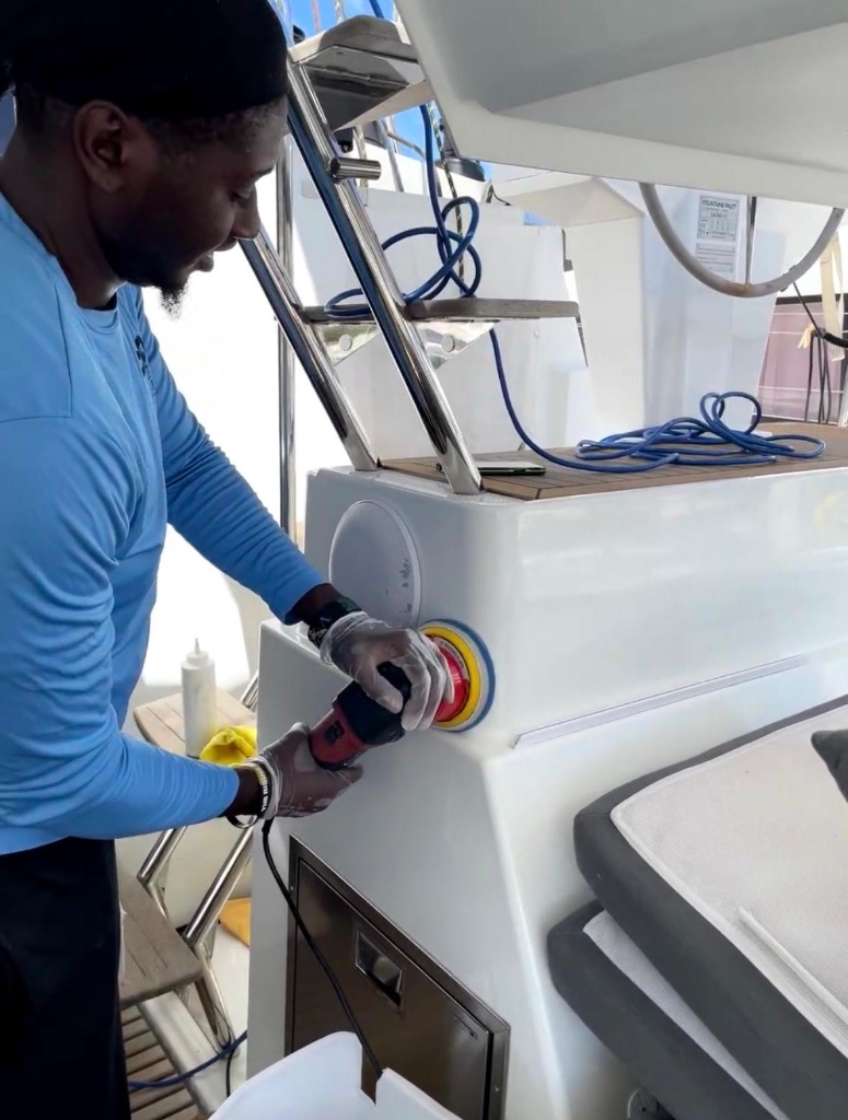 Deshawn polishing yacht with orbital buffer — Scrubbies Boat Wash 340 St. Thomas USVI