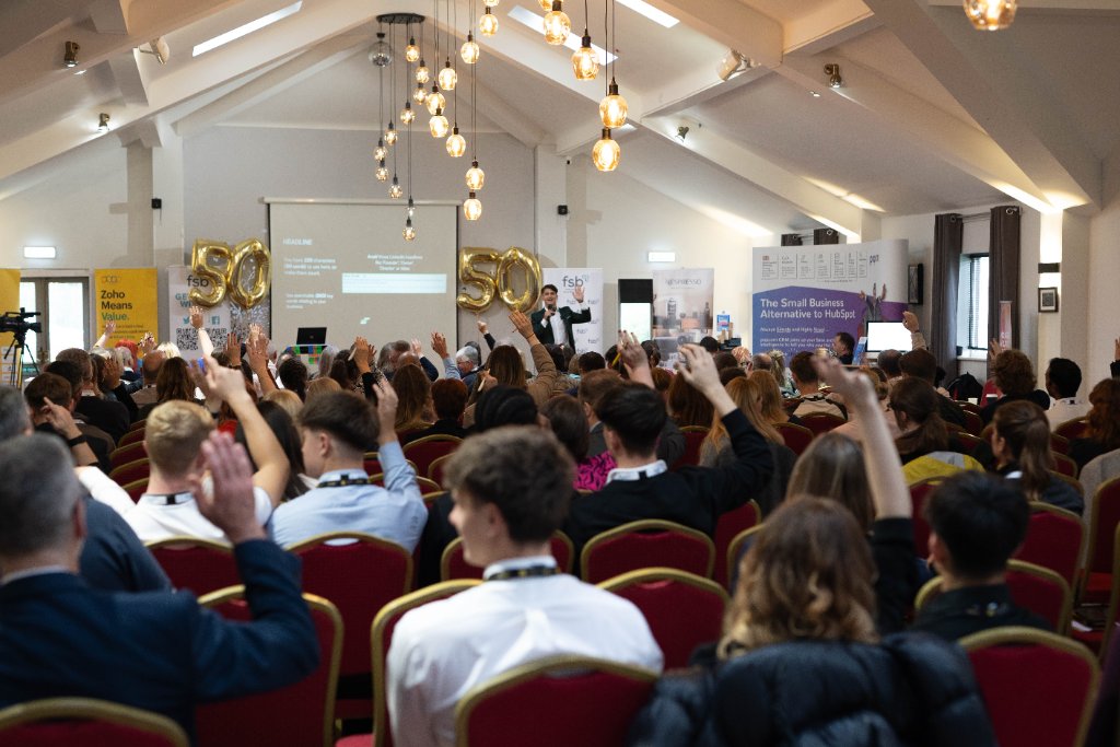 Packed audience of business owners and marketing professionals watching Elliot Ghali speak on stage at an FSB Sheffield event