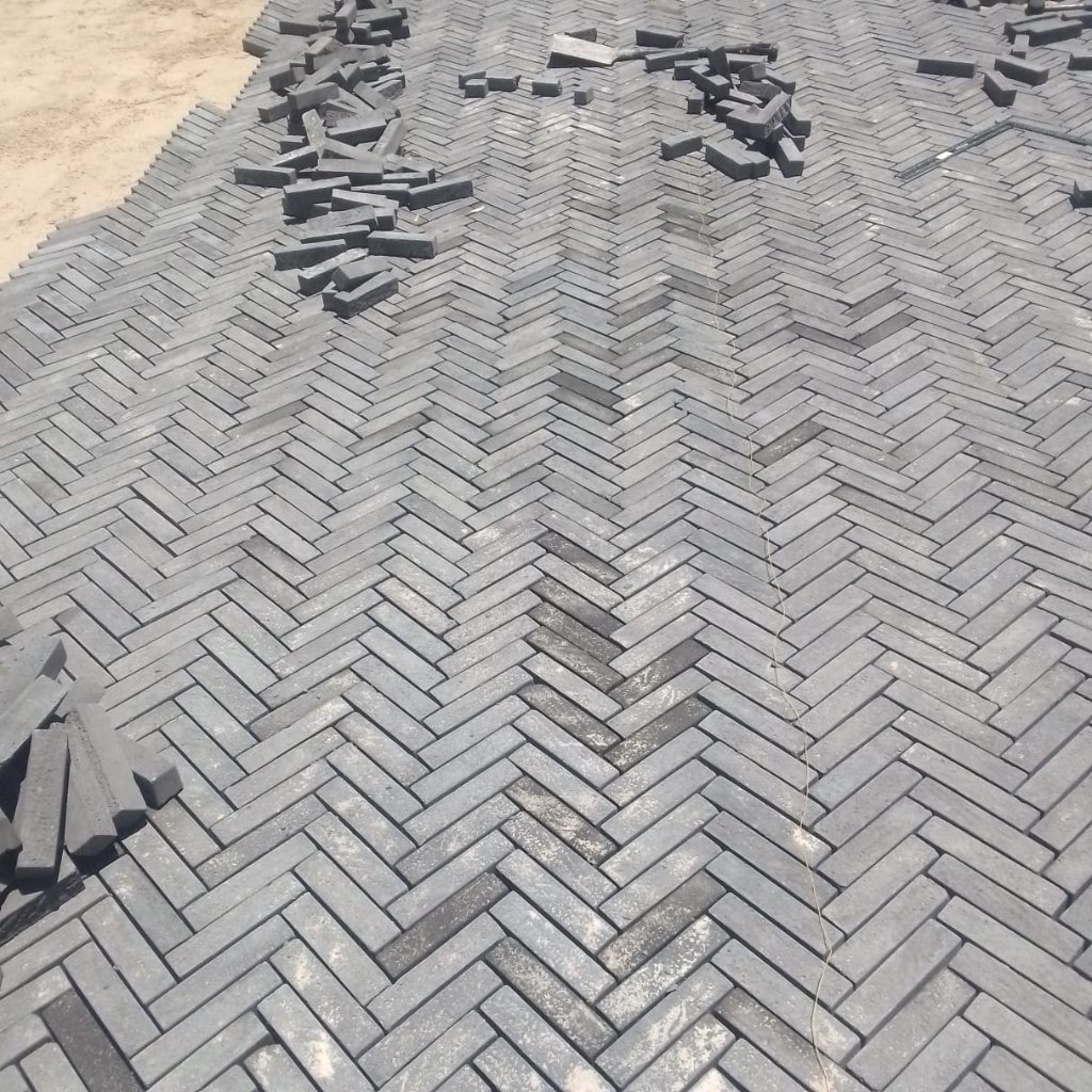 Herringbone pattern brick paving installation