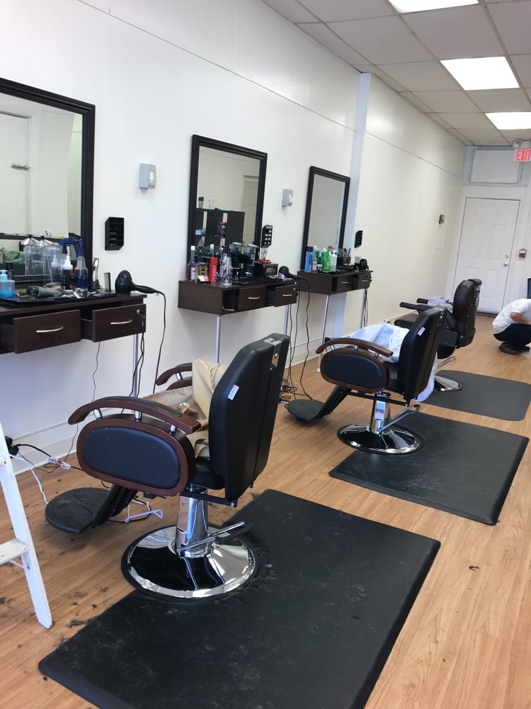 Barber giving a fade haircut at Joe's Barber Shop in Newtonville MA