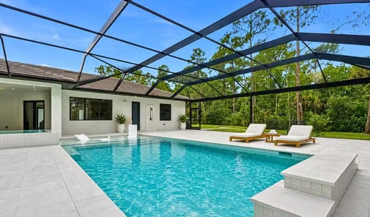 The screened-in pool and spa at 181 18th Ave NW, Naples