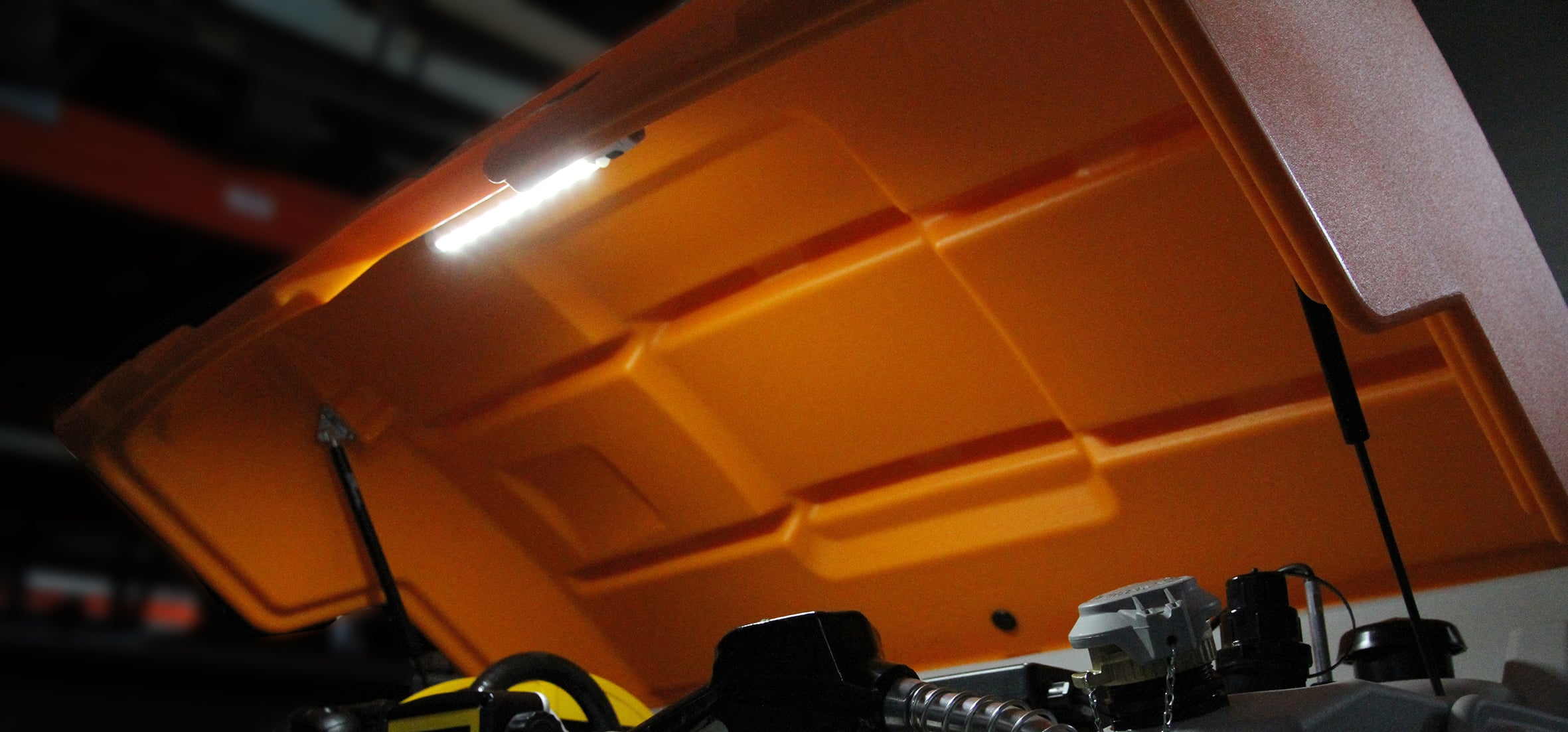 Hinged lid, orange with supporting gas struts and mounting accessories