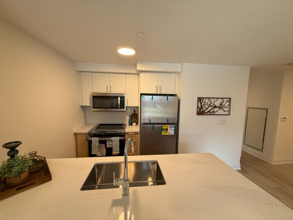 Kitchen with quartz island and stainless sink