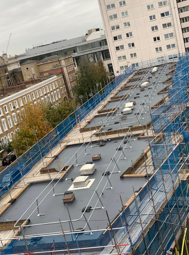 Rocathaan HotSpray dusk application — spray polyurea roofing system