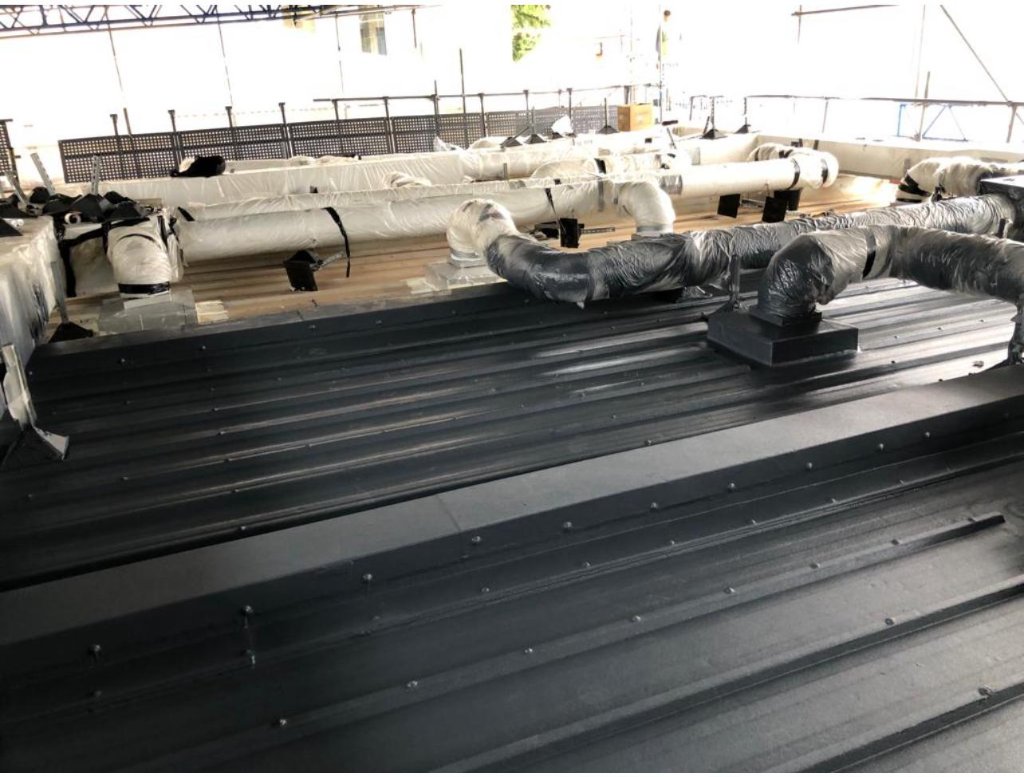 TopSpray35 roof coating with penetrations — metal roof refurbishment