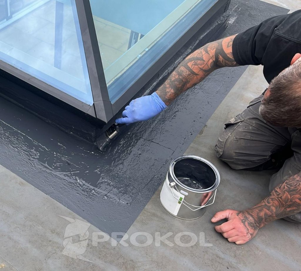 ProFix MS Hybrid Polymer sealant applied around a rooflight upstand — trained applicator performing localised detail waterproofing