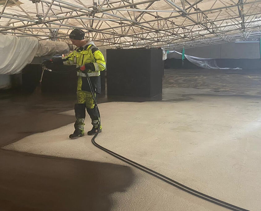 Spray-applied commercial roof coating on a Manchester warehouse