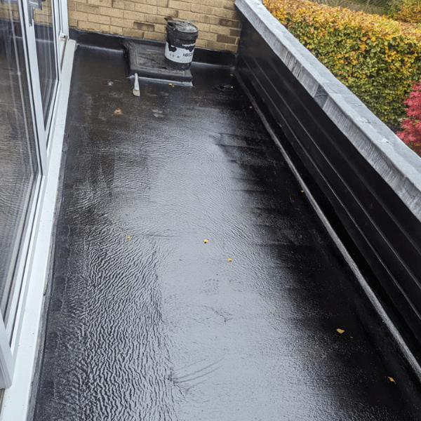 HBS200 seamless liquid rubber membrane freshly applied to flat roof — glossy black finish