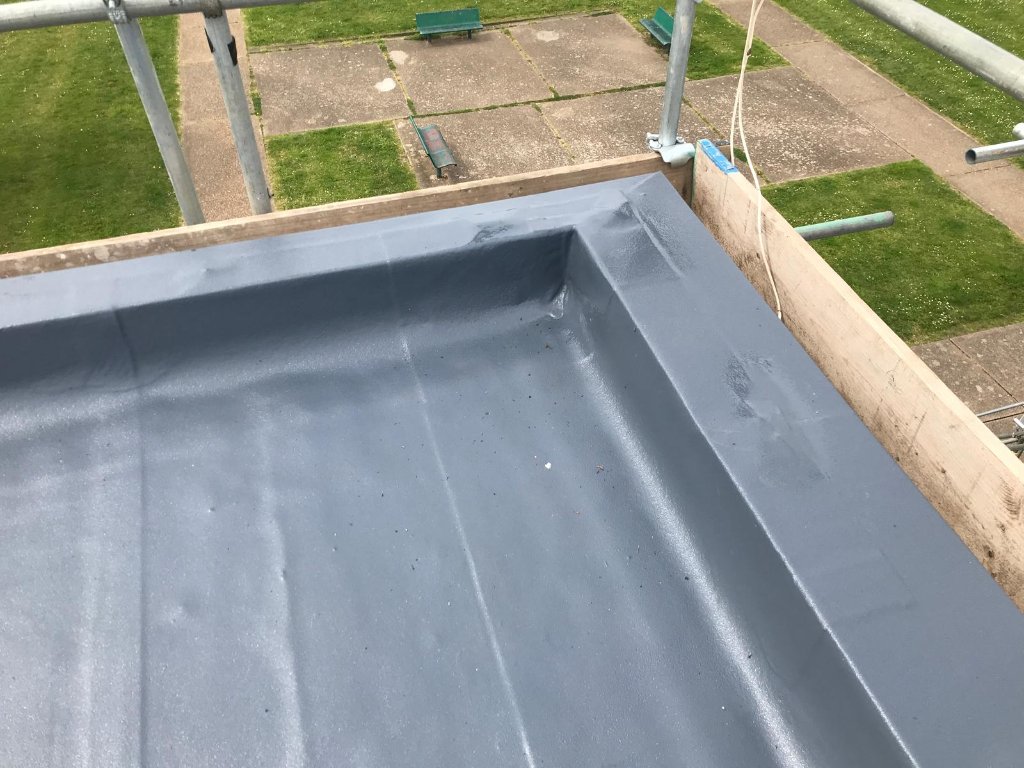 Rocathaan HotSpray roof with solar panels — polyurea waterproofing system