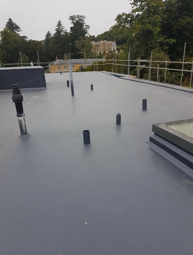 Rocathaan HotSpray flat roof with penetrations — seamless spray membrane detailing