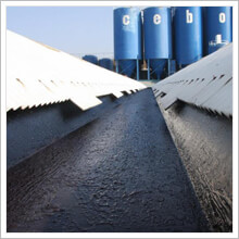 SprayGrade two-component liquid rubber applied to commercial roof with edge detailing