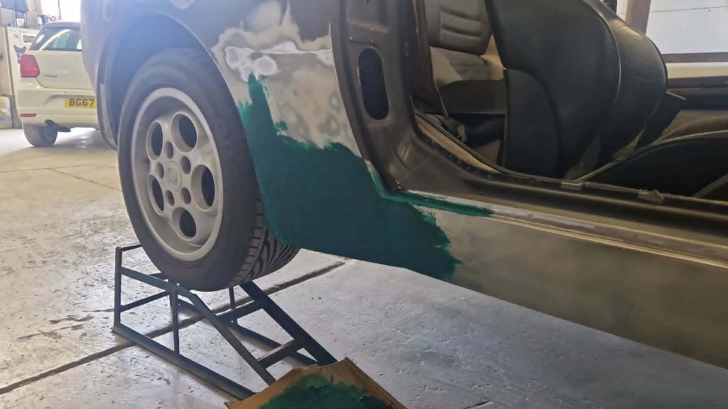 White estate respray in spray booth under infrared curing lamps