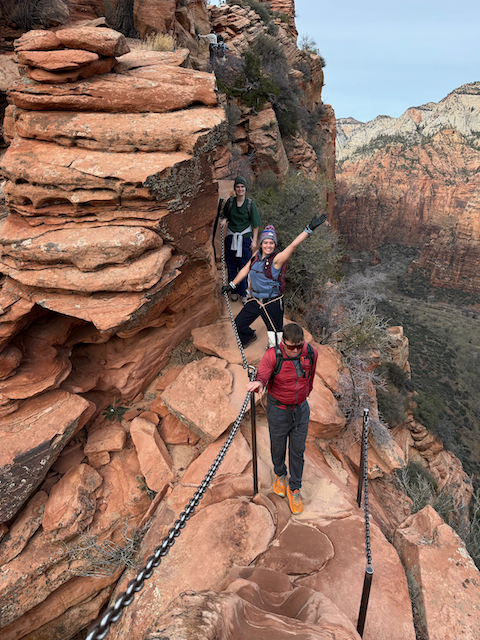 Group of hikers ascending the narrow chain section of Angels Landing