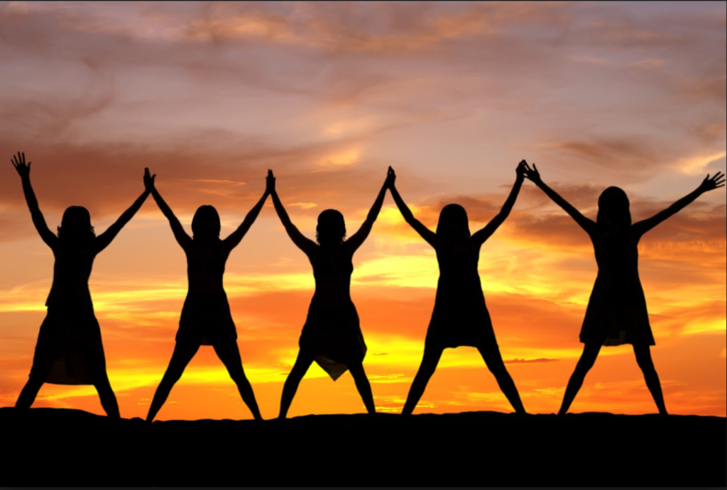 Women celebrating at sunset