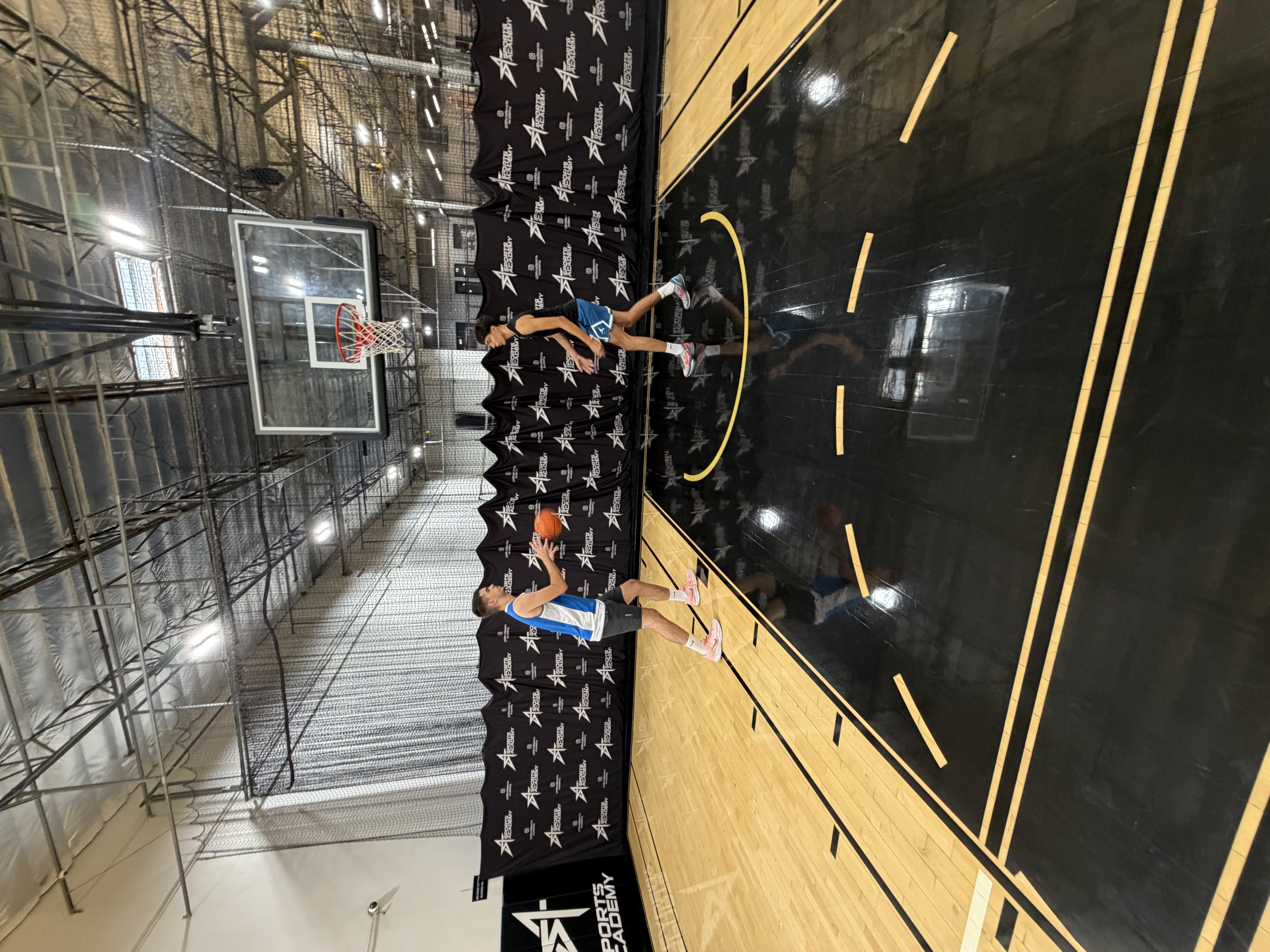 Athletes training near the basket at Sports Academy