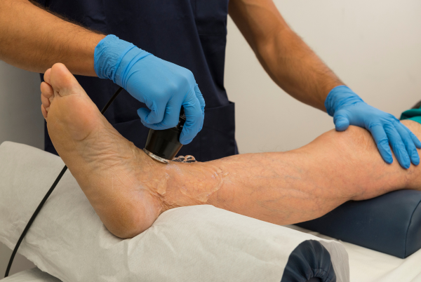 Therapeutic ultrasound treatment being applied to a patient's soft tissue