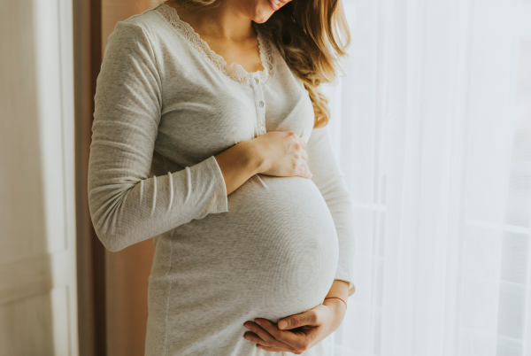 Pregnant woman receiving gentle chiropractic care at Wheat Chiropractic