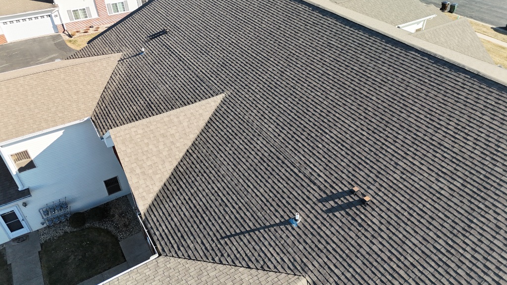 Drone aerial catching a poor shingle installation — overlapping, crooked courses found during an inspection