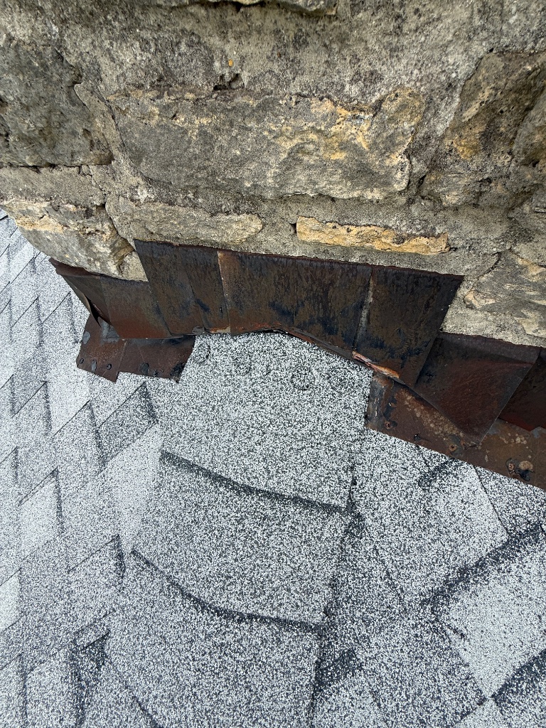 Exposed nail heads covered and sealed at chimney flashing