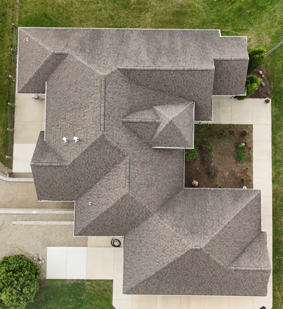 L-shaped residential roof with brown shingles