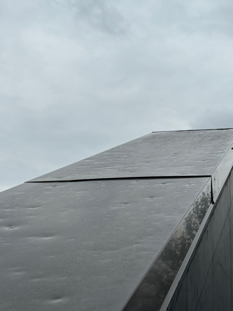 Metal roof hail denting close-up