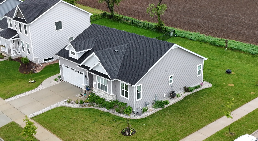 Gray-sided home with black asphalt roof