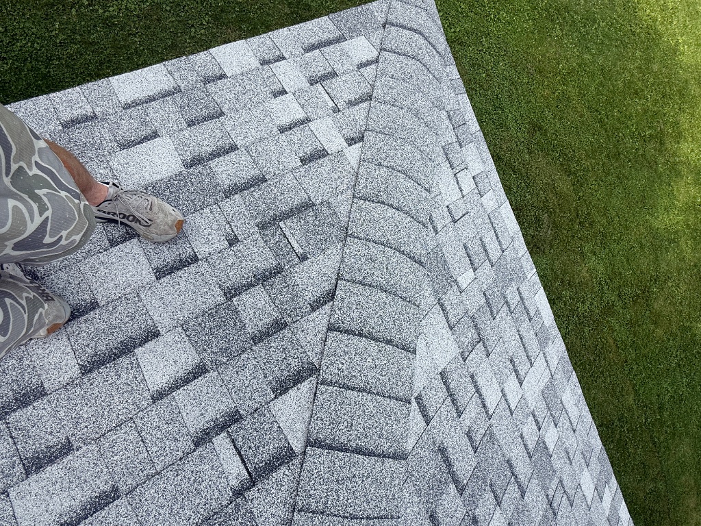 New ridge cap shingle installed at roof ridge