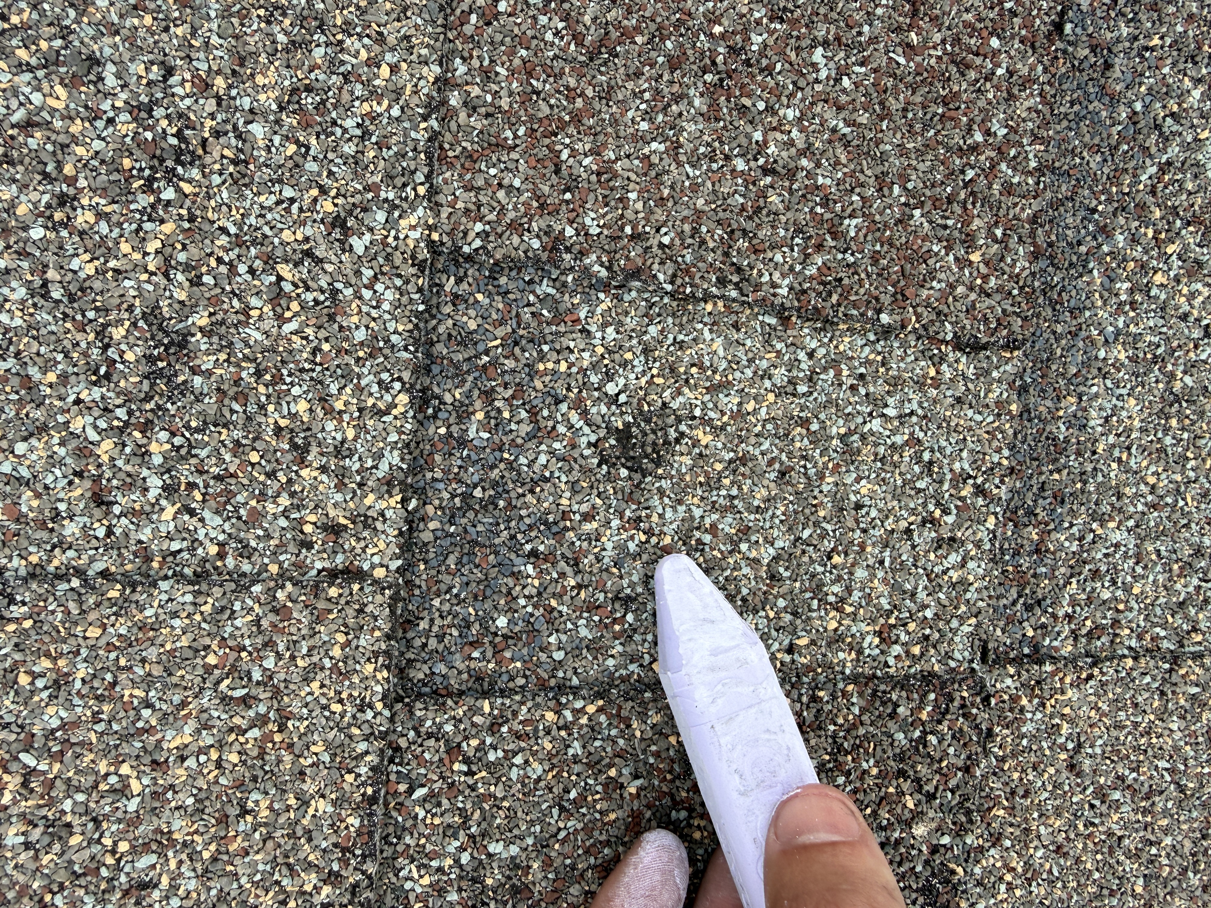 Shingle granule loss marked with chalk