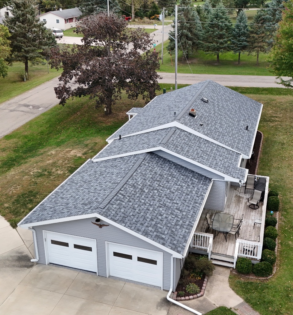 Grey shingle roof with deck and patio