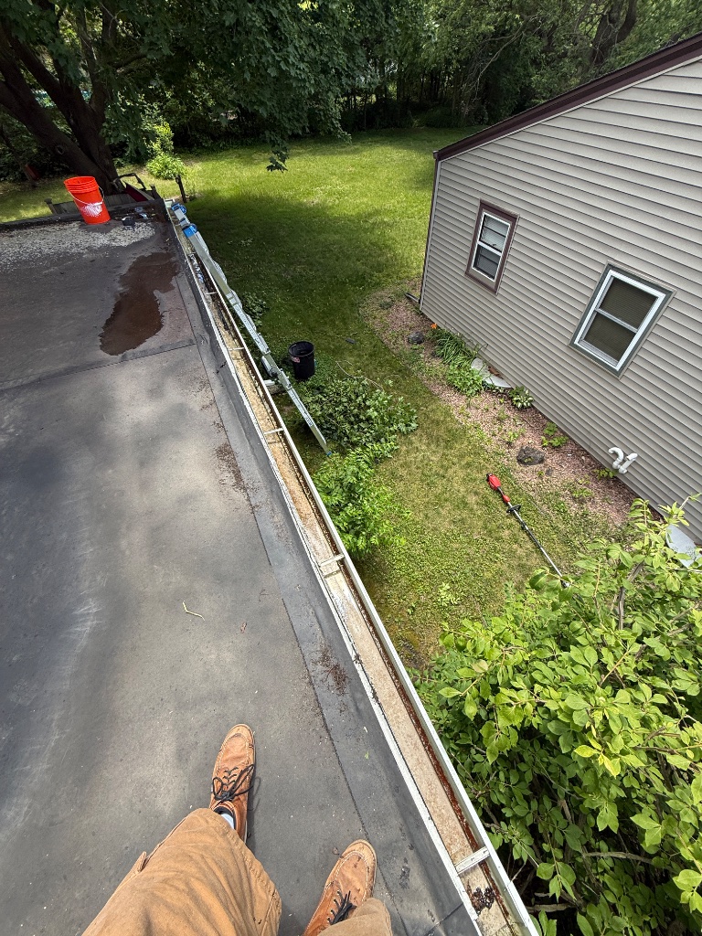 Gutter after cleaning — debris cleared and flowing