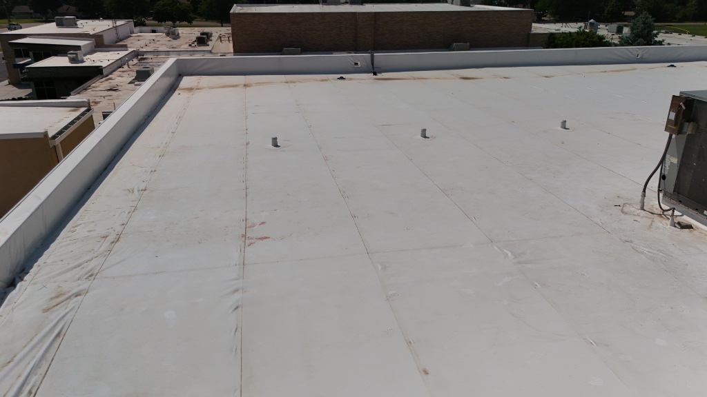 Flat commercial roof — membrane surface with HVAC units